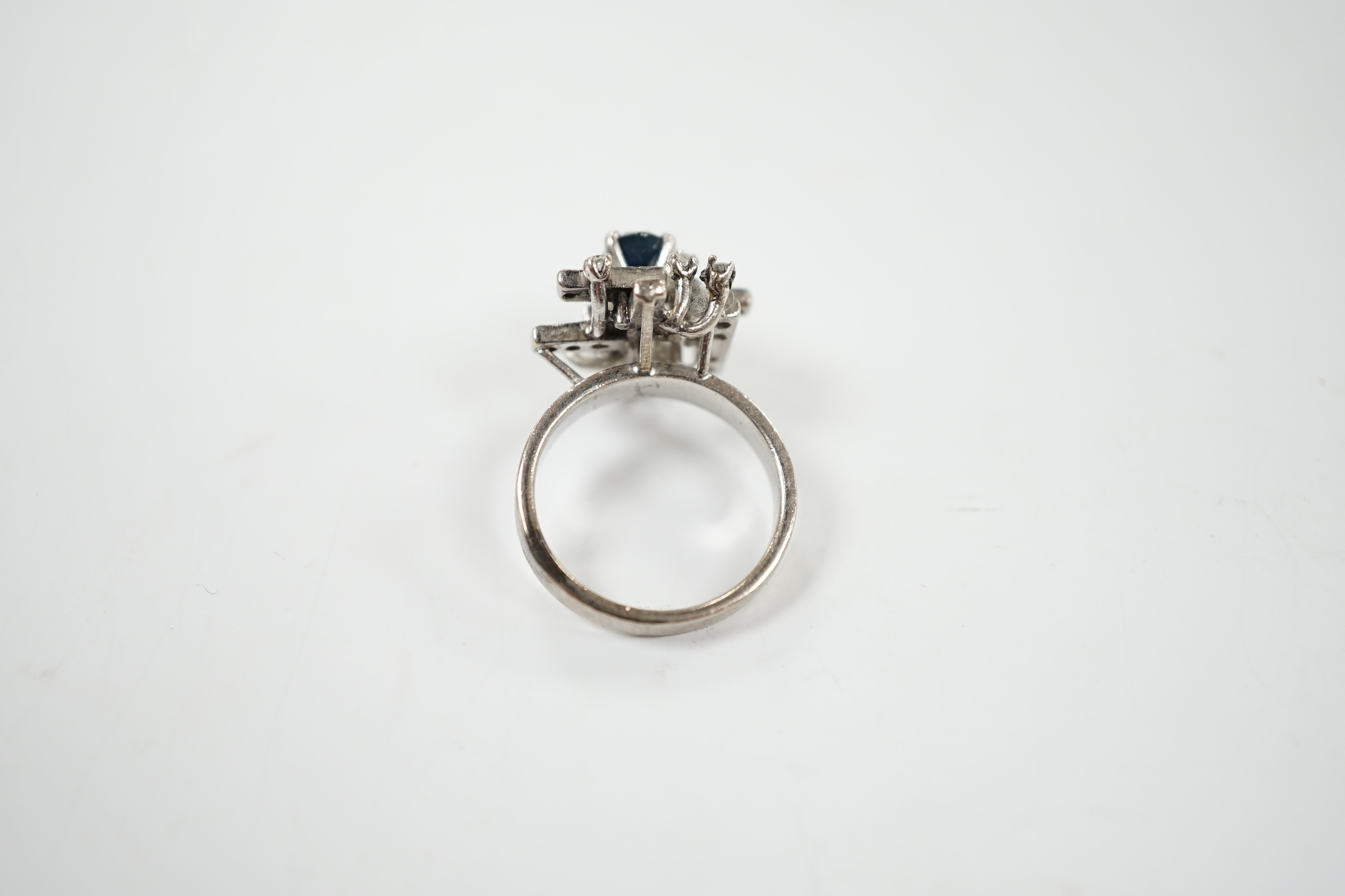 A modern 18k white metal, sapphire and diamond set modernist ring, size K/L, gross weight 6.1 grams.